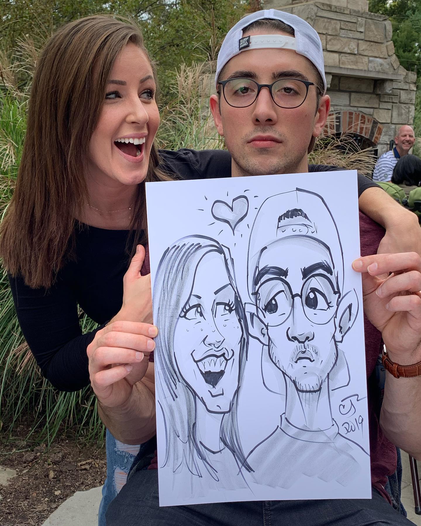 Couple at a party with their caricature