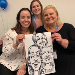 Three party guests with their new caricature. Three women smile as they hold their new caricature