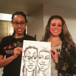 Two party guests take home their super-fun party favor. Two girls holding their caricature